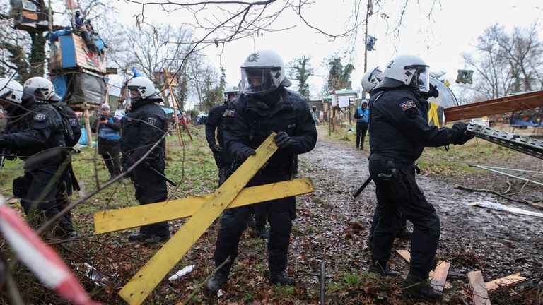 Police officers remove barricades as activists stage a sit-in protest against the expansion of the Garzweiler open-cast lignite mine of Germany&#39;s utility RWE, in Luetzerath, 