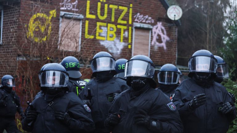 Police officers stand guard during a demonstration at Luetzerath, a village that is about to be demolished to allow for the expansion of the Garzweiler open-cast lignite mine of Germany&#39;s utility RWE, in Luetzerath, Germany, January 11, 2023. REUTERS/Wolfgang Rattay