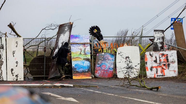 Environmental activists work on a barricade near the demolition edge of the Garzweiler II opencast lignite mine in Luetzerath, Germany, Thursday, Jan. 5, 2023. According to police, they have once again cleared a barricade for safety reasons at the occupied village of Luetzerath. The village of Luetzerath is abandoned by its inhabitants but occupied by opponents of lignite mining to protest against the further expansion fossil energy. (Rolf Vennenbernd/dpa via AP). Pic: AP