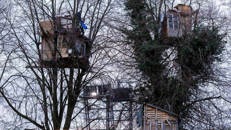 Treehouses built into trees, as part of a protest camp against an opencast lignite mine in Luetzerath, Germany, December 20, 2022. The eviction of the camp announced for January 2023 as the shovel to ignition now works within 100 meters of the protest camp.  (Rolf Vennenberg/dpa via AP).  Photo: AP