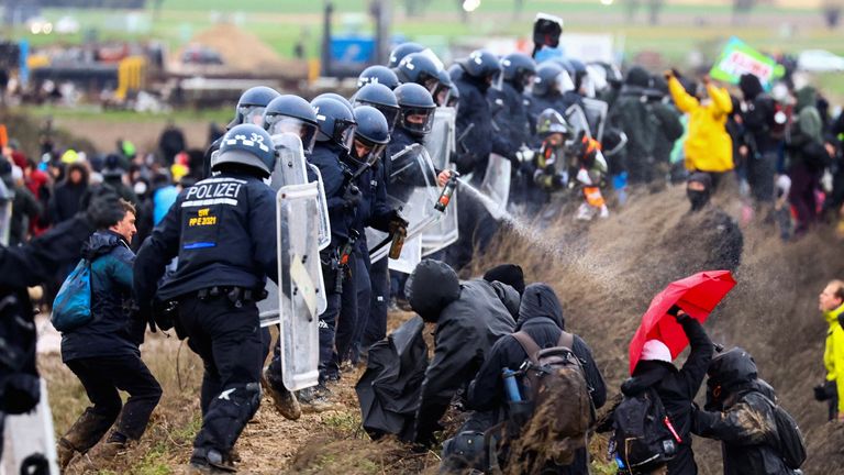 Police officers spray activists during a protest against the expansion of Germany&#39;s utility RWE&#39;s Garzweiler open-cast lignite mine to Luetzerath, Germany, January 14, 2023. REUTERS/Christian Mang
