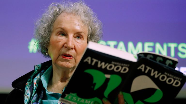 FILE - Canadian author Margaret Atwood holds a copy of her book "The Testaments," during a news conference on Sept. 10, 2019, in London. A years-long saga that ensnared the publishing world culminated in a New York courtroom Friday, Jan. 6, 2023, when a con artist pleaded guilty to a plot that defrauded scores of authors, including Atwood, by duping them into handing over hundreds of unpublished manuscripts. (AP Photo/Alastair Grant, File)