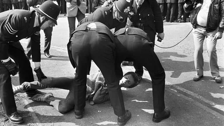  Police grapple with a floored picket at the Orgreave Coking Plant, near Rotherham, as lorry loads of coke leave for the British Steel Corporation&#39;s Scunthorpe plant, 40 miles away.
Arrests came as the pickets, who had been kept well away from the entrance by scores of policeman, suddenly started to rush the police lines.