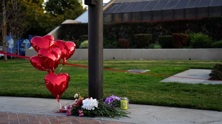 Flowers and heart balloons are left near the scene of a shooting that took place during a Chinese Lunar New Year celebration, in Monterey Park, California, U.S. January 22, 2023. REUTERS/Allison Dinner