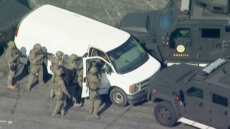 Police use armored vehicles to surround a white cargo van, believed by law enforcement to be connected to the Monterey Park mass shooting suspect according to an ABC affiliate, as a SWAT team approaches at a parking lot in Torrance, California, U.S. January 22, 2023 in a still image from video. ABC Affiliate KABC via REUTERS NO RESALES. NO ARCHIVES. MANDATORY CREDIT
