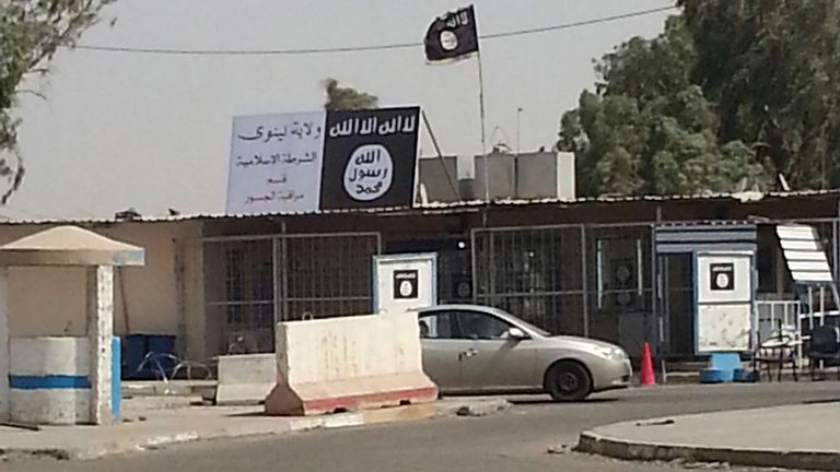 A sign (in white) by the Islamic State is seen in the city of Mosul July 21, 2014. Using its own version of "soft" and "hard" power, the Islamic State is crushing resistance across northern Iraq so successfully that its promise to march on Baghdad may no longer be unrealistic bravado. While conventional states try to win hearts and minds abroad before necessarily resorting to military force, the jihadist group is also achieving its aims by psychological means - backed up by a reputation for extr