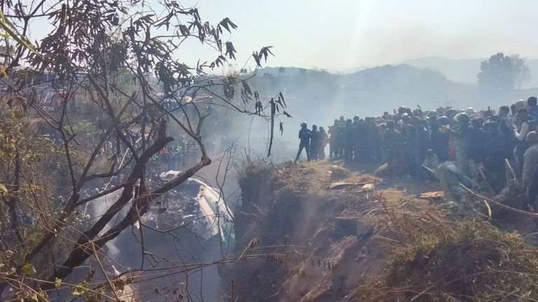 Crowds gather at the crash site