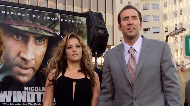 Actor Nicolas Cage arrives with girlfriend Lisa Marie Presley at the Los Angeles premiere of his new film "Windtalkers" in Hollywood June 11, 2002. "Windtalkers" opens June 14 in the United States. REUTERS/Fred Prouser FSP/SV