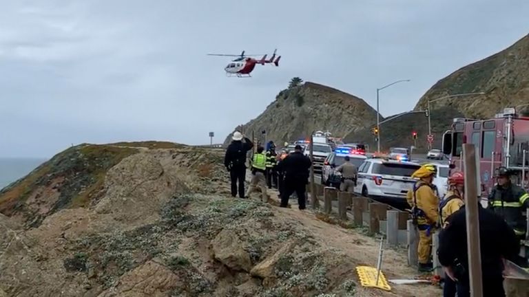 Emergency crews respond to the scene in video provided by Cal Fire San Mateo Santa Cruz after a Tesla fell off a cliff along the Pacific Coast Highway on Monday, Jan. 1. Four people are in critical condition near an area known as Devil's Landslide in northern California, Feb. 2, 2023, a fire official said. (Cal Fire San Mateo - Santa Cruz Unit via AP)