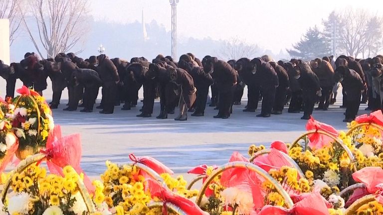 North Koreans bow in front of statues of previous leaders on New Year&#39;s Day
