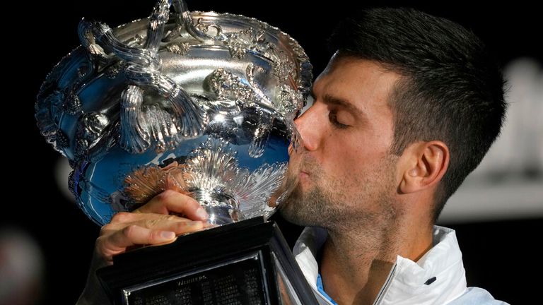 Novak Djokovic of Serbia kisses the Norman Brookes Challenge Cup, after defeating Stefanos Tsitsipas of Greece in the men&#39;s singles final at the Australian Open tennis championship in Melbourne, Australia, Sunday, Jan. 29, 2023. (AP Photo/Dita Alangkara)