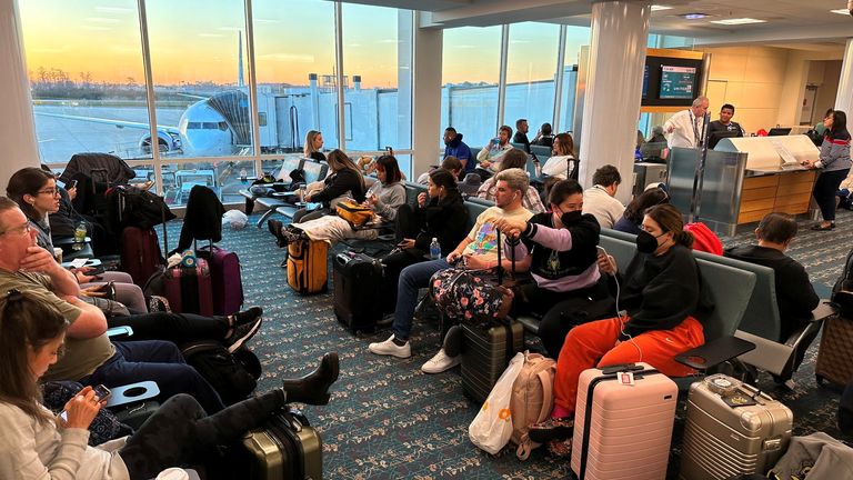 Stranded passengers wait at the Orlando International Airport, as flights were grounded after FAA system outage