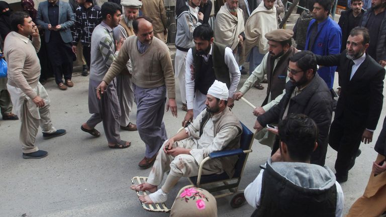 Men move an injured victim, after a suicide blast in a mosque, at hospital premises in Peshawar, Pakistan January 30, 2023. REUTERS/Khuram Parvez
