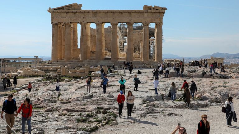 People visit the ancient Parthenon Temple atop the Acropolis hill archaeological site in Athens, Greece, February 26, 2022. Picture taken February 26, 2022. REUTERS/Louiza Vradi