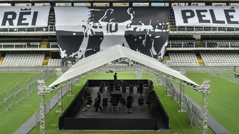 Workers prepare the staging area for the funeral of the late Brazilian soccer legend Pele on center field of the Vila Belmiro stadium, home of the Santos soccer club, in Santos, Brazil, Saturday, Dec. 31, 2022.  Pele, who played most of his career with Santos, died in Sao Paulo on Thursday at the age of 82. (AP Photo/Matias Delacroix)