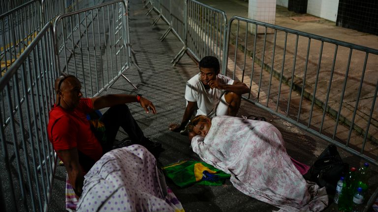 Soccer fans sleep outside the Villa Belmiro stadium as they wait for the gates to open for the funeral of late Brazilian soccer star Pele, Monday, Jan. 2, 2023, in Santos, Brazil.
