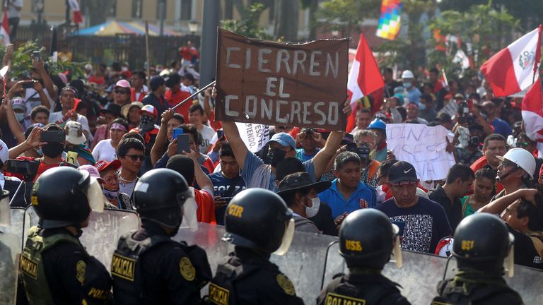 A person is holding a sign reading "Closing of the congress"