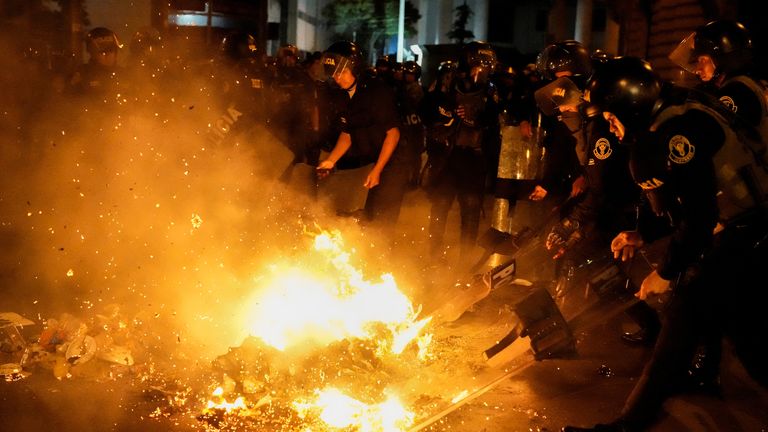 Riot police put out the fire lit by the protesters during the &#39;Take over Lima&#39; demonstration against Peru&#39;s President Dina Boluarte, following the ousting and arrest of former President Pedro Castillo, in Lima, Peru January 20, 2023. REUTERS/Angela Ponce