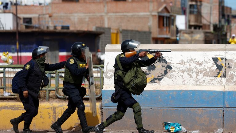 Peruvian police officers operate as demonstrators hold a protest demanding early elections and the release of Peruvian ousted leader Pedro Castillo, in Juliaca, Peru  