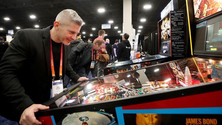 Amit Cotler of Israel tries out a connected Stern Pinball machine, which can recognize the player with a QR code and post scores to a global leaderboard, during the CES Unveiled press event at CES 2023, an annual consumer electronics trade show, in Las Vegas, Nevada, U.S. January 3, 2023. REUTERS/Steve Marcus
