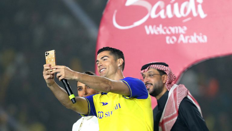 New Al Nassr signing Cristiano Ronaldo takes a selfie during his presentation