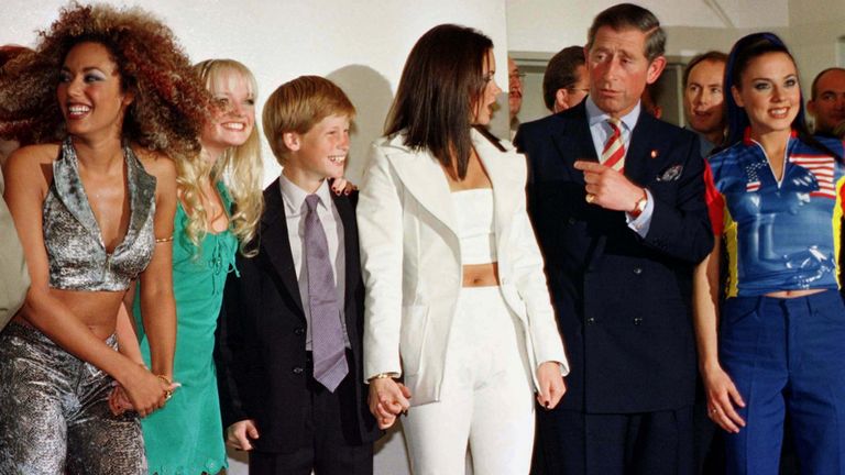 Britain&#39;s Prince Charles (2nd R) and Prince Harry meet Spice Girls (L-R) Geri, Mel B, Emma, Victoria (holding the Prince&#39;s hand) and Mel C backstage during the "Two Nations" Concert in Johannesburg November 1. Prince Charles is on the second day of his South African visit. SAFRICA PRINCE HARRY

