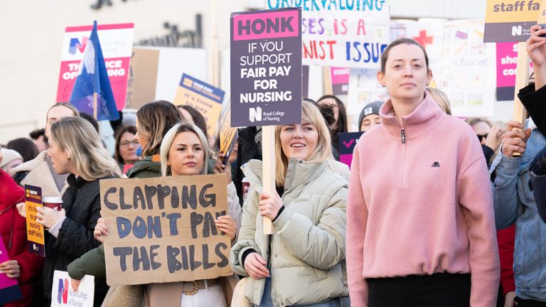 Members of the RCN pictured on the fence outside St Thomas' Hospital, central London, on December 20