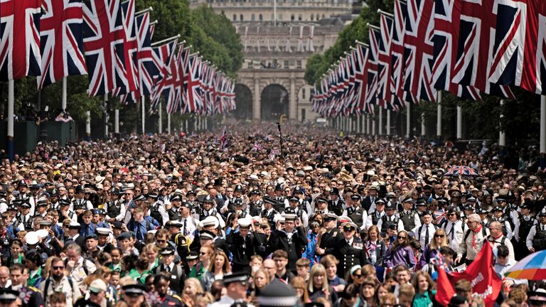 Crowds watch as Queen Elizabeth makes an appearance in the balcony of Buckingham Palace, to watch the special flypast by the Britain&#39;s RAF (Royal Air Force) following the Trooping the Colour parade, as a part of her platinum jubilee celebrations