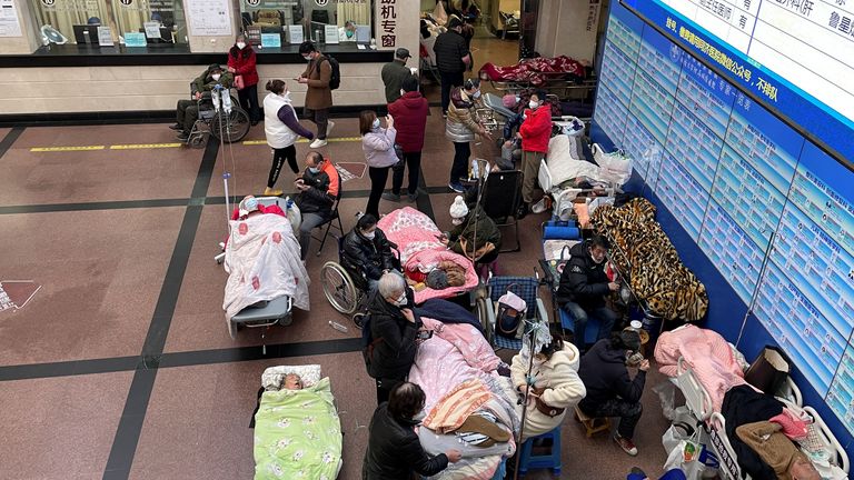 Patients lie on beds and stretchers in the hallway of a hospital emergency department during the outbreak of the coronavirus disease (COVID-19) in Shanghai, China.