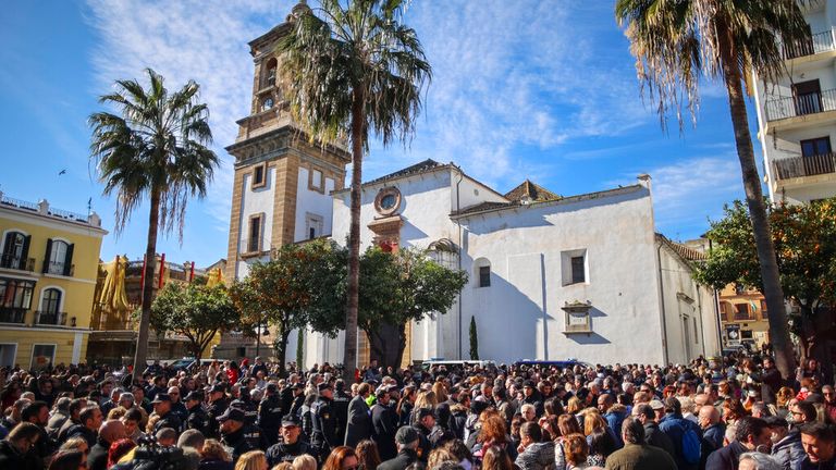 Residents gather after a minute's silence for a church sexton who was killed in Algeciras