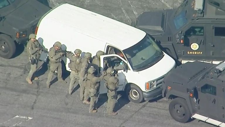 Police surround van of shooting suspect