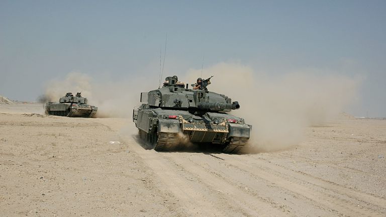 British soldiers patrol on two Challenger 2 tanks in the desert near Basra, Iraq, June 2006. Photo by: Carl Schulze/picture-alliance/dpa/AP Images


