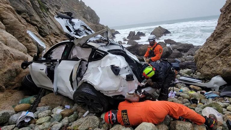 Rescuers work on retrieving a destroyed Tesla sedan that had plunged off a cliff in an area called the Devil's Slide in San Mateo County, California January 2, 2023. San Mateo County Sheriff's Office/Handout via REUTERS THIS IMAGE HAS BEEN SUPPLIED BY A THIRD PARTY.