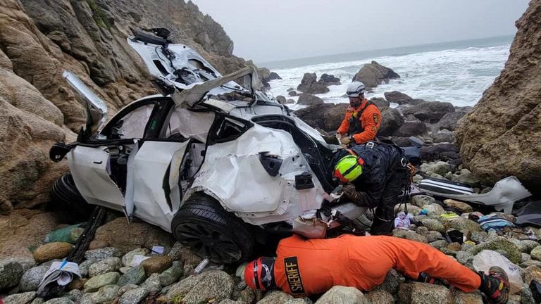 Rescuers rescue a destroyed Tesla sedan that fell off a cliff in an area known as Devil's Slide in San Mateo County, California, on January 2, 2023. San Mateo County Sheriff's Office/Handout via Reuters This photo was provided by a third party.