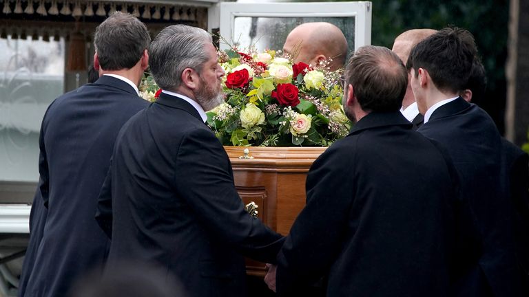 The bearer party, including father Tim Edwards (second left) lift the coffin of Elle Edwards into a carriage following her funeral service,