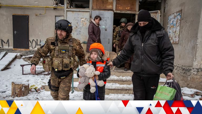 Policemen help Arina, 6, dressed in children&#39;s bulletproof vest and helmet during her evacuation from front line city of Bakhmut, amid Russia&#39;s attack on Ukraine, in Donetsk region, Ukraine January 31, 2023. REUTERS/Oleksandr Ratushniak