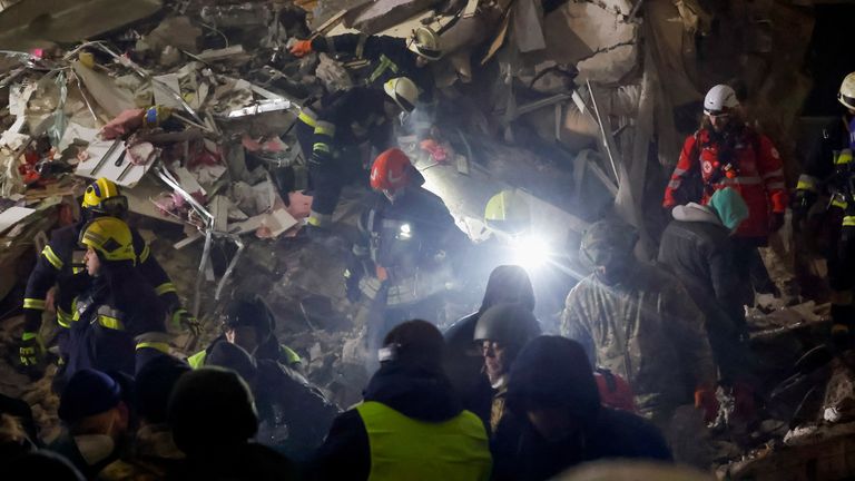 Emergency personnel work at the site where an apartment block was heavily damaged by a Russian missile strike, amid Russia&#39;s attack on Ukraine, in Dnipro, Ukraine January 15, 2023. REUTERS/Clodagh Kilcoyne