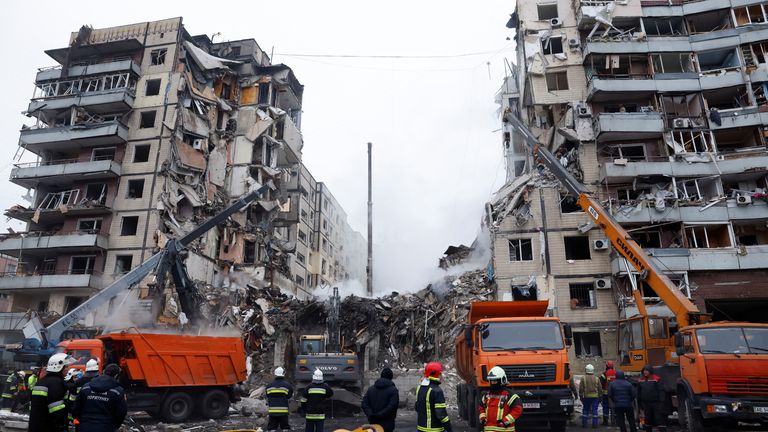 Emergency personnel work at the site to find survivors of the missile attack