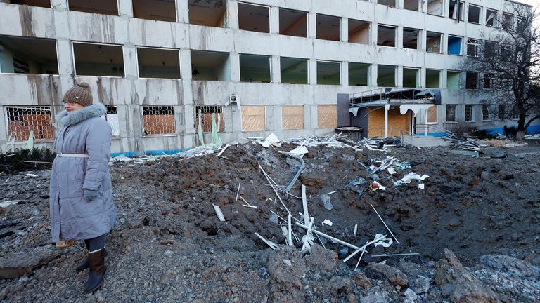 A woman stands at the site of a Russian missile strike in Kramatorsk, Ukraine