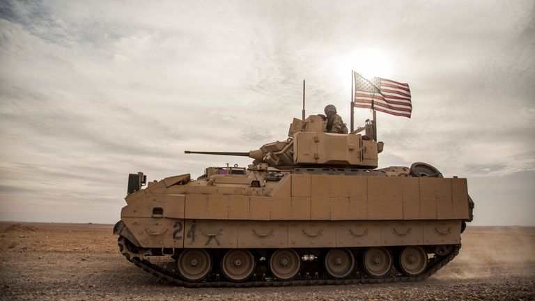 FILE - American soldiers drive a Bradley fighting vehicle during a joint exercise with Syrian Democratic Forces at the countryside of Deir Ezzor in northeastern Syria, Dec. 8, 2021. The U.S. and Germany are sending Ukraine an array of armored vehicles, including 50 tank-killing Bradleys, to expand its ability to move troops to the front lines and beef up its forces against Russia as the war nears its first anniversary. (AP Photo/Baderkhan Ahmad, File)