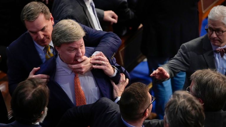 Rep. Richard Hudson, R-N.C., left, pulls Rep. Mike Rogers, R-Ala., back as they talk with Rep. Matt Gaetz, R-Fla., and other during the 14th round of voting for speaker as the House meets for the fourth day to try and elect a speaker and convene the 118th Congress in Washington, Friday, Jan. 6, 2023. At right is Rep. Patrick McHenry, R-N.C. (AP Photo/Andrew Harnik)