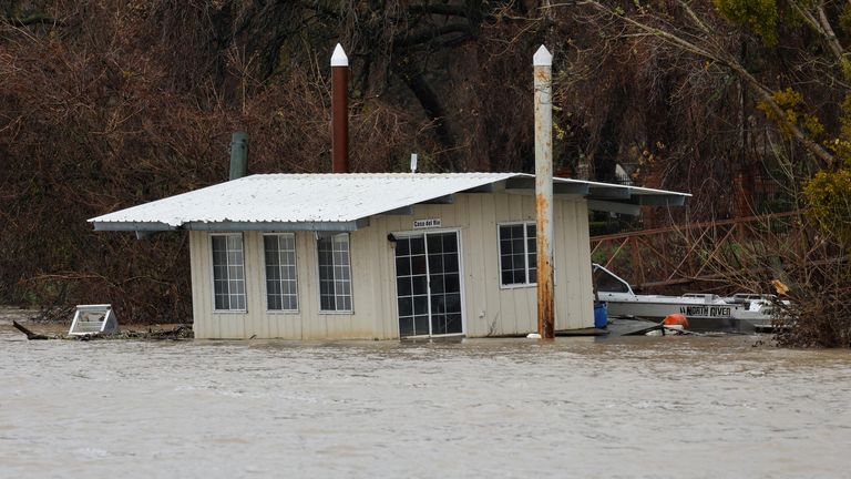 A partially submerged boathouse is seen on the Sacramento River, which level has risen due to storms, in West Sacramento, California, U.S. January 4, 2023. REUTERS/Fred Greaves
