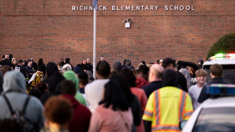 Students and police gather outside Richneck Elementary School after the shooting, Friday, Jan. 1.  June 2023 in Newport News, Virginia. Police and school officials in Newport News said Friday that a teacher was taken to the hospital after a shooting at an elementary school in Virginia, and finally... one person... was taken into custody... (Billy Schuerman/The Virginian- Pilot via AP)
