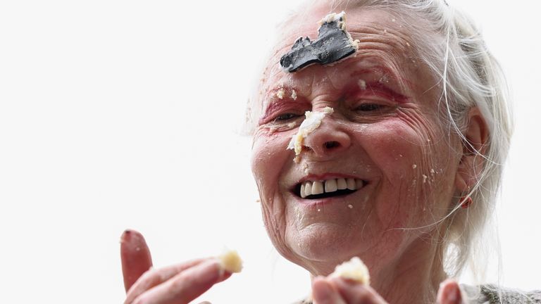 Fashion designer Vivienne Westwood smears cake on her face as she attends a picnic protest marking Wikileaks founder Julian Assange&#39;s 50th Birthday, on Parliament Square in London, Britain, July 3, 2021. REUTERS/Henry Nicholls