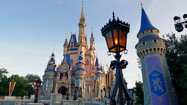 The newly painted Cinderella Castle at the Magic Kingdom at Walt Disney World is seen with the the crest to celebrate the 50th anniversary of the theme park Monday, Aug. 30, 2021, in Lake Buena Vista, Fla. (AP Photo/John Raoux)