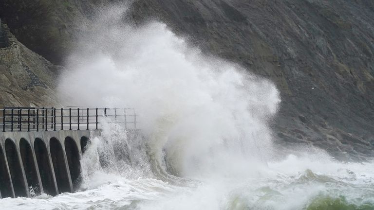 Waves crash over the promenade during rain and strong winds at Folkestone, Kent.