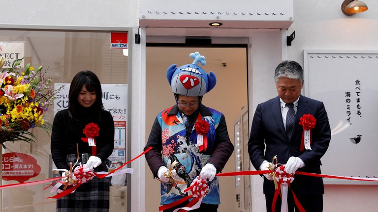 President of the Japanese whale-hunting company Kyodo Senpaku Kaisha Ltd, Hideki Tokoro, along with whale meat consumer Mao Kaneko and the General Director of Motomachi Shopping Street Hiroshi Takarada cut the ribbon on the opening ceremony of his comapny&#39;s shop in Yokohama, Japan