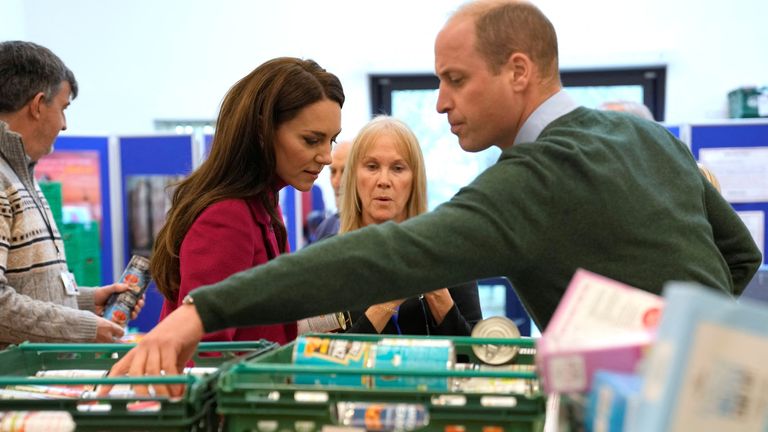 Kate, Princess of Wales, and Prince William check food baskets during a visit to Windsor Foodshare in Windsor
