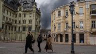 People walk in a street as smoke rises in the air after shelling in Odesa (file image). Pic: AP