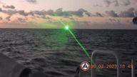 A green light appears from the direction of a Chinese coast guard ship at the Second Thomas Shoal, 105 nautical miles off the Palawan Province, Philippines